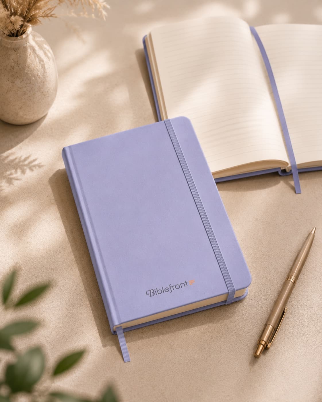 Biblefront notebook beside an open view of its lined warm-ivory pages